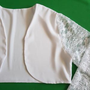 Kb. M-es hófehér színű, csipkés ujjú, menyasszonyi boleró