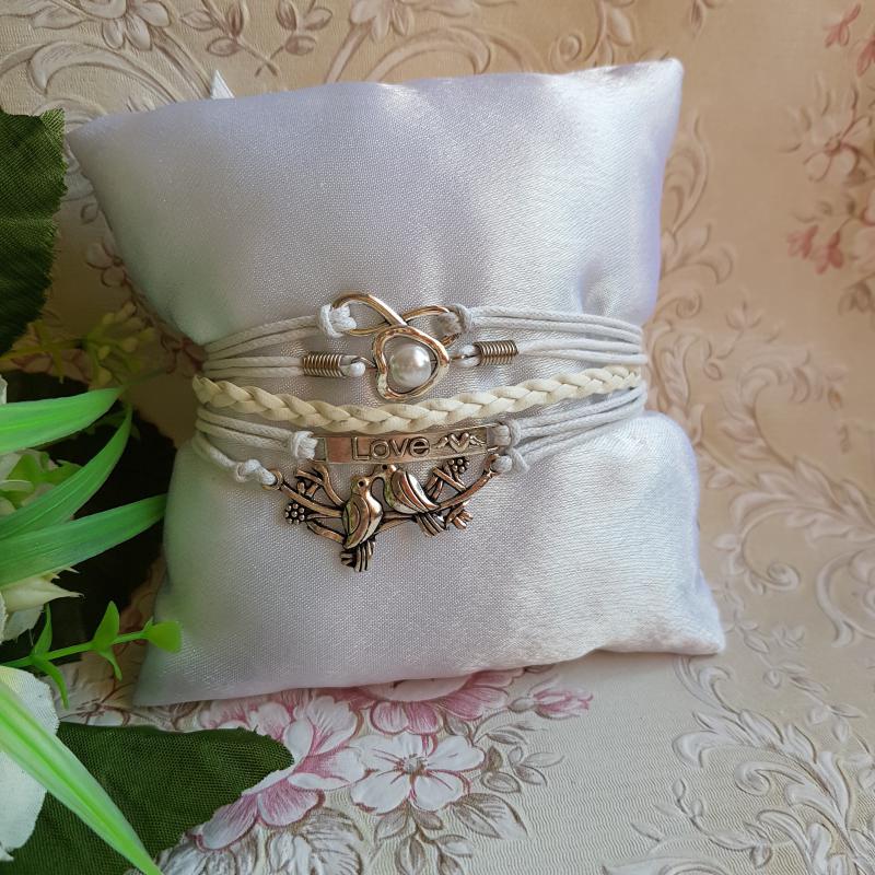 Fehér színű műbőr karkötő fém díszekkel - galamb, LOVE, szív